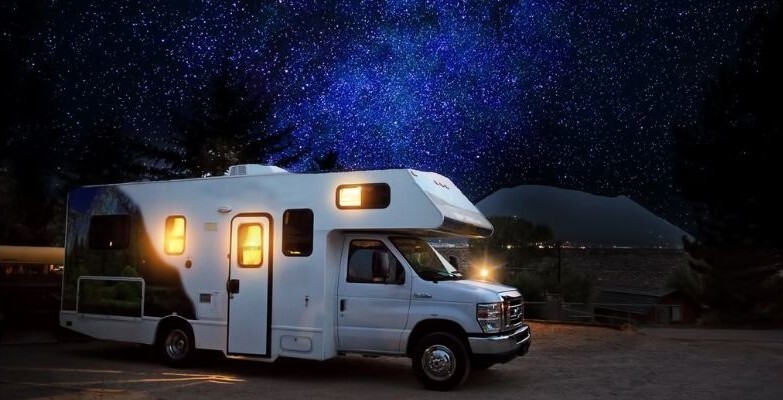 RV camping under dark starry sky