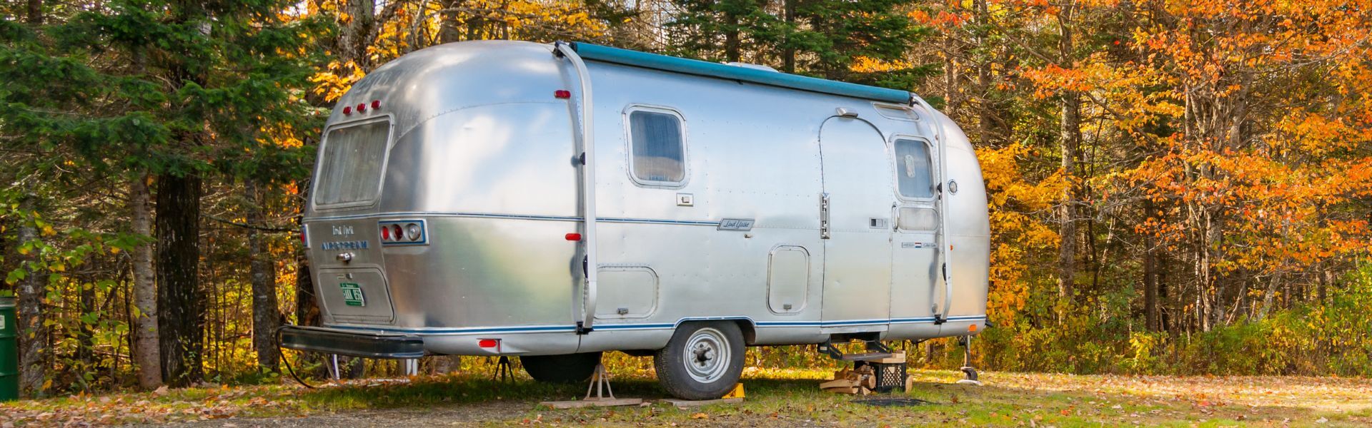 Airstream camper in colorful fall foliage setting