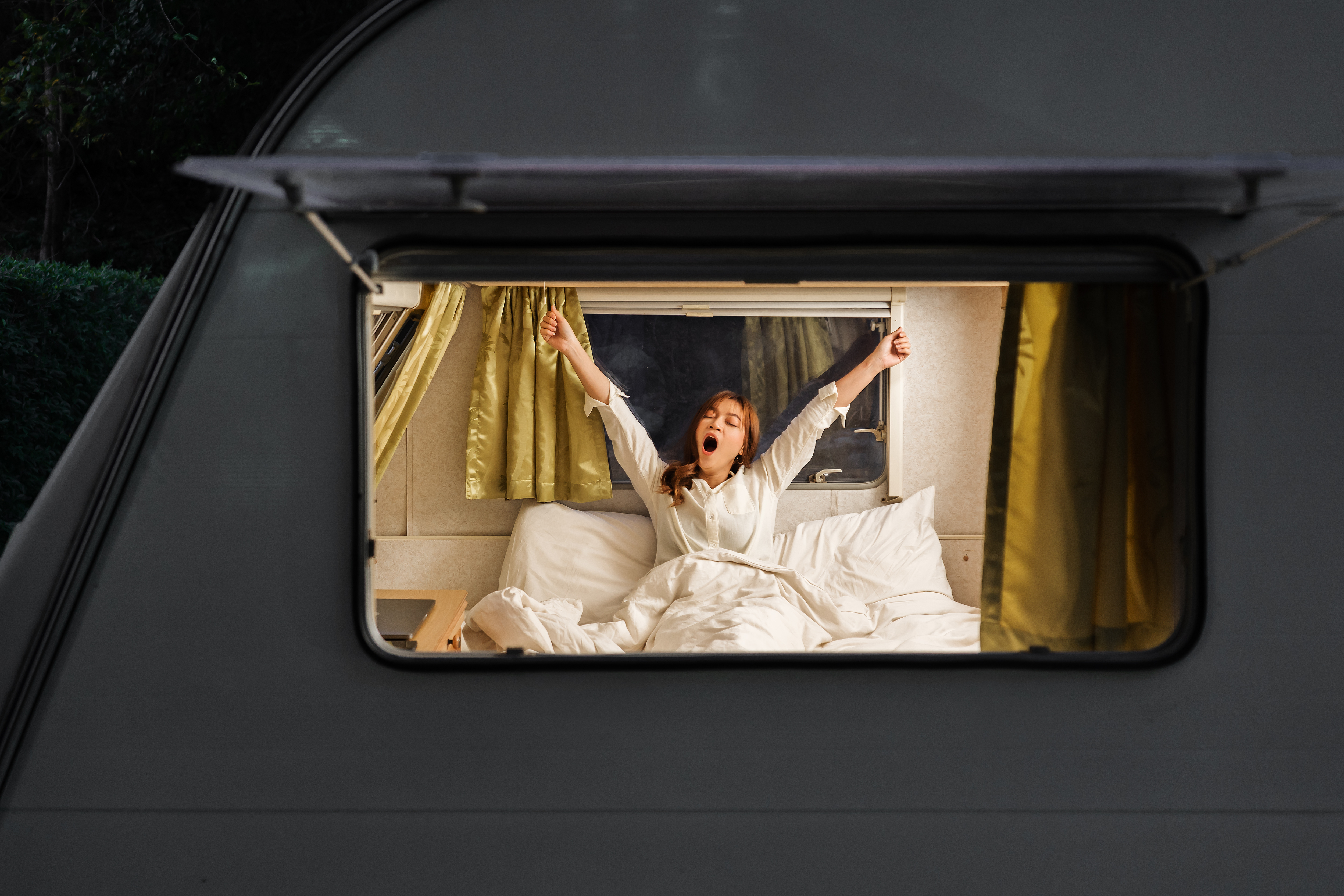 Woman waking up in camper