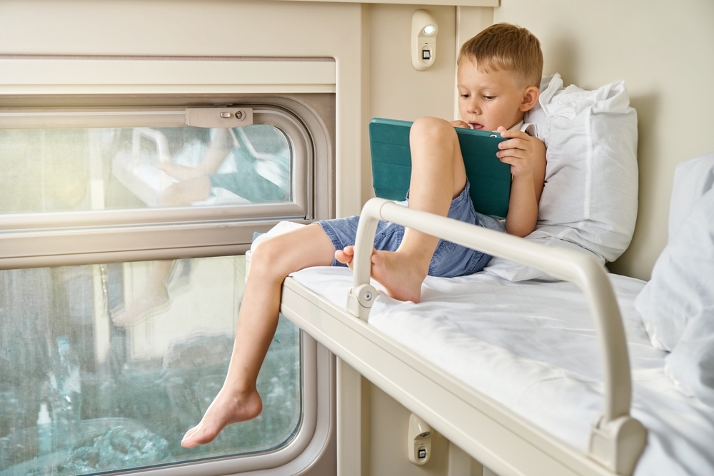 boy reading in RV bunk bed